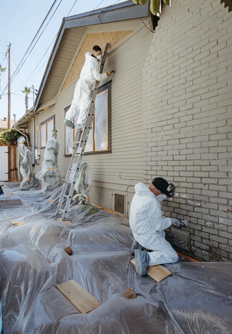 M1-TEX crew masking and repainting a brick home exterior