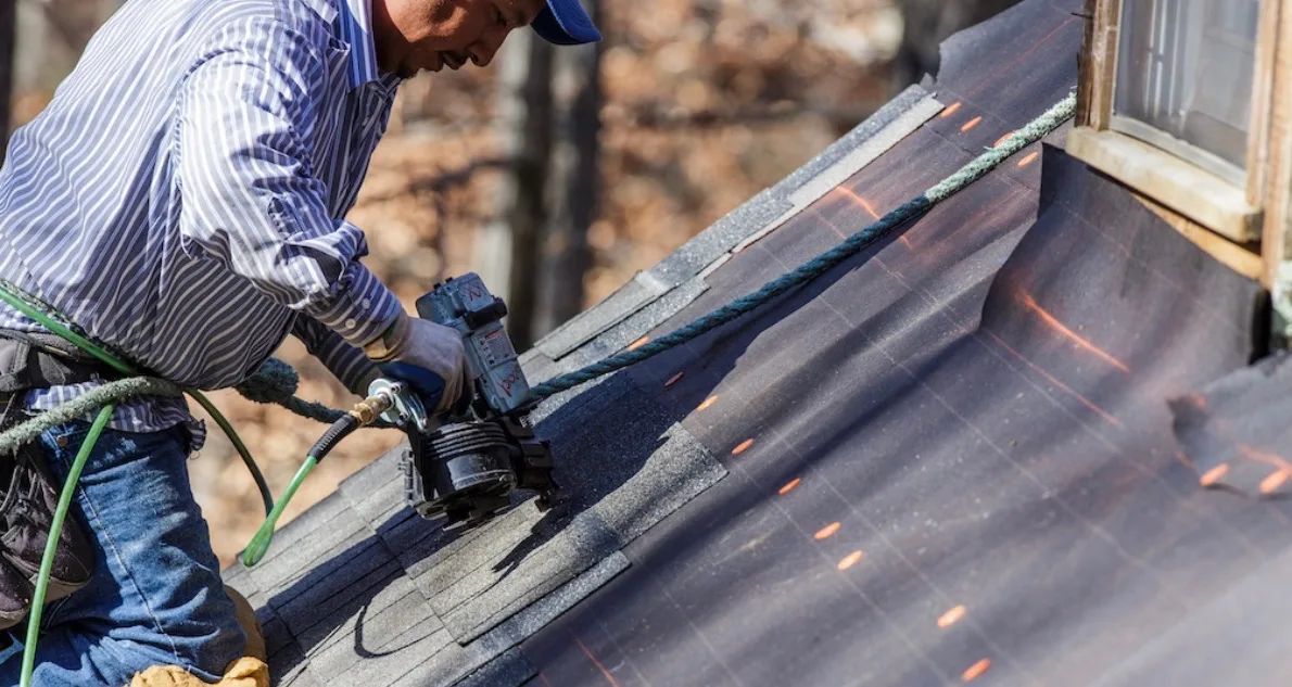 Roofing professional installing architectural shingles