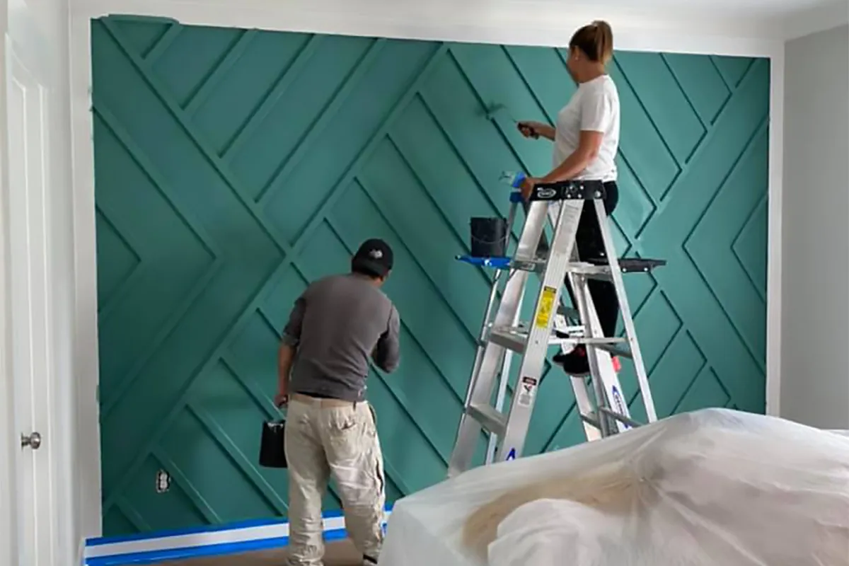 M1-TEX crew painting a geometric teal accent wall